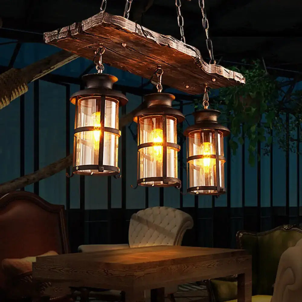 Rustic wooden plank pendant light with three clear glass island lanterns in brass for farmhouse brown bistro ceiling hang