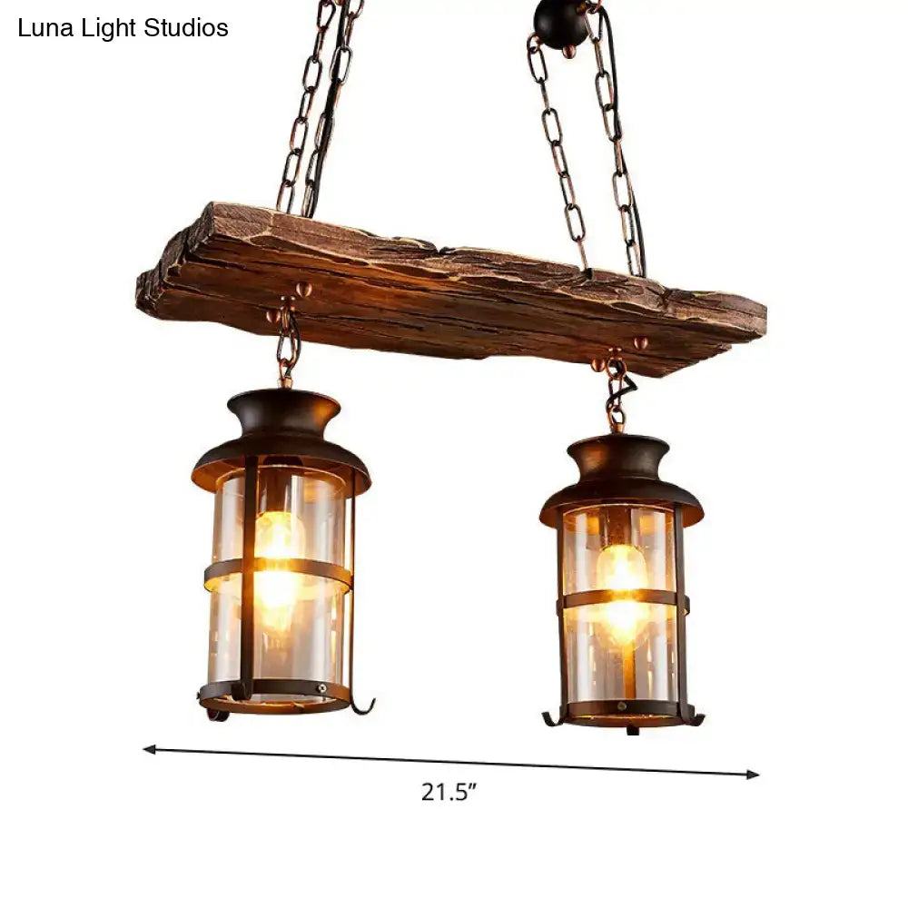 Rustic wooden beam with two dark metal framed pendant lights featuring clear glass panels in decorbites clear glass island design