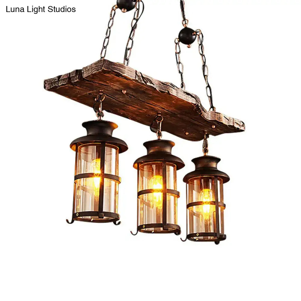 Rustic wooden plank pendant light with three brass lanterns and clear glass panels for clear glass island use