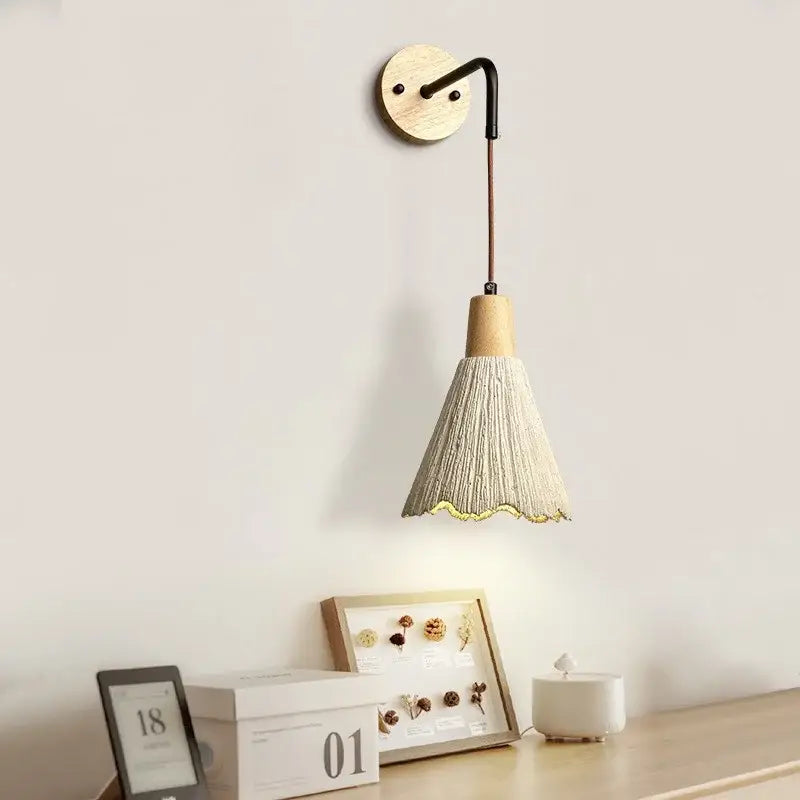 Rustic wood and gray wall light fixture with wooden base and beige woven conical shade with scalloped edge and pull chain