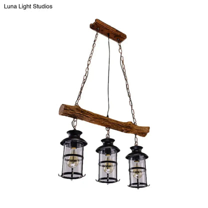 DecorBites™ nautical clear glass cluster pendant with wood design features three black lantern-style fixtures in brown