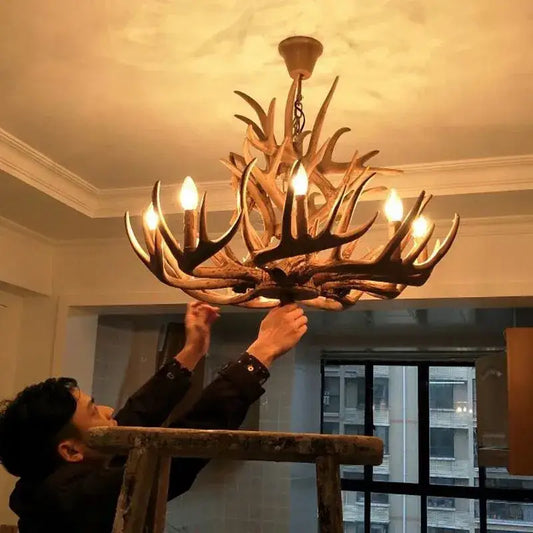 Rustic wood finish decorbites deer antler chandelier with warm natural tones and multiple lit bulbs for dining room lighting