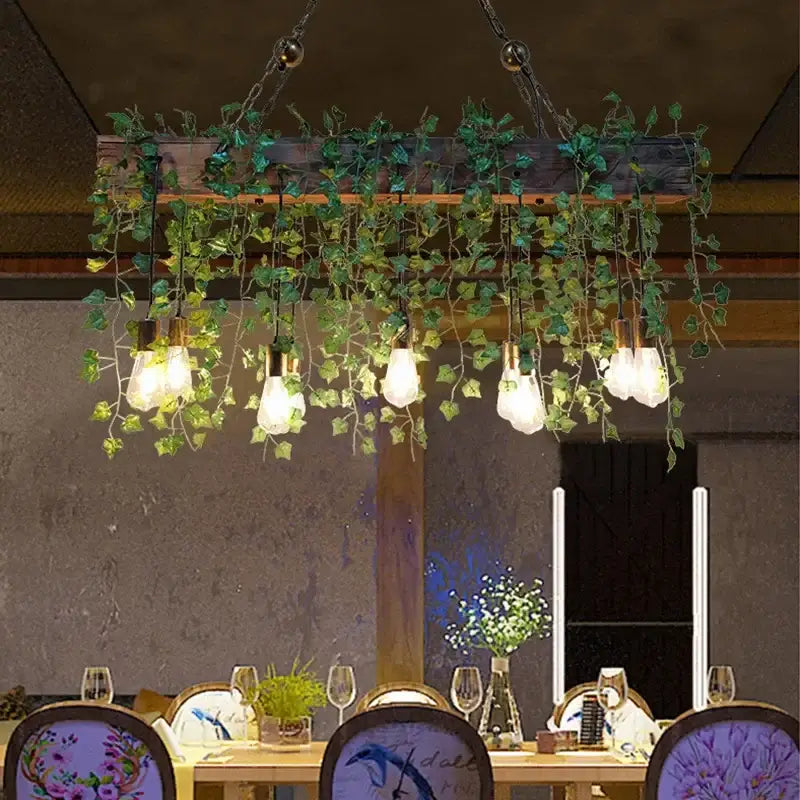Rustic wood hanging chandelier with lush green ivy and Edison bulbs ideal for bar hanging chandeliers and dining rooms