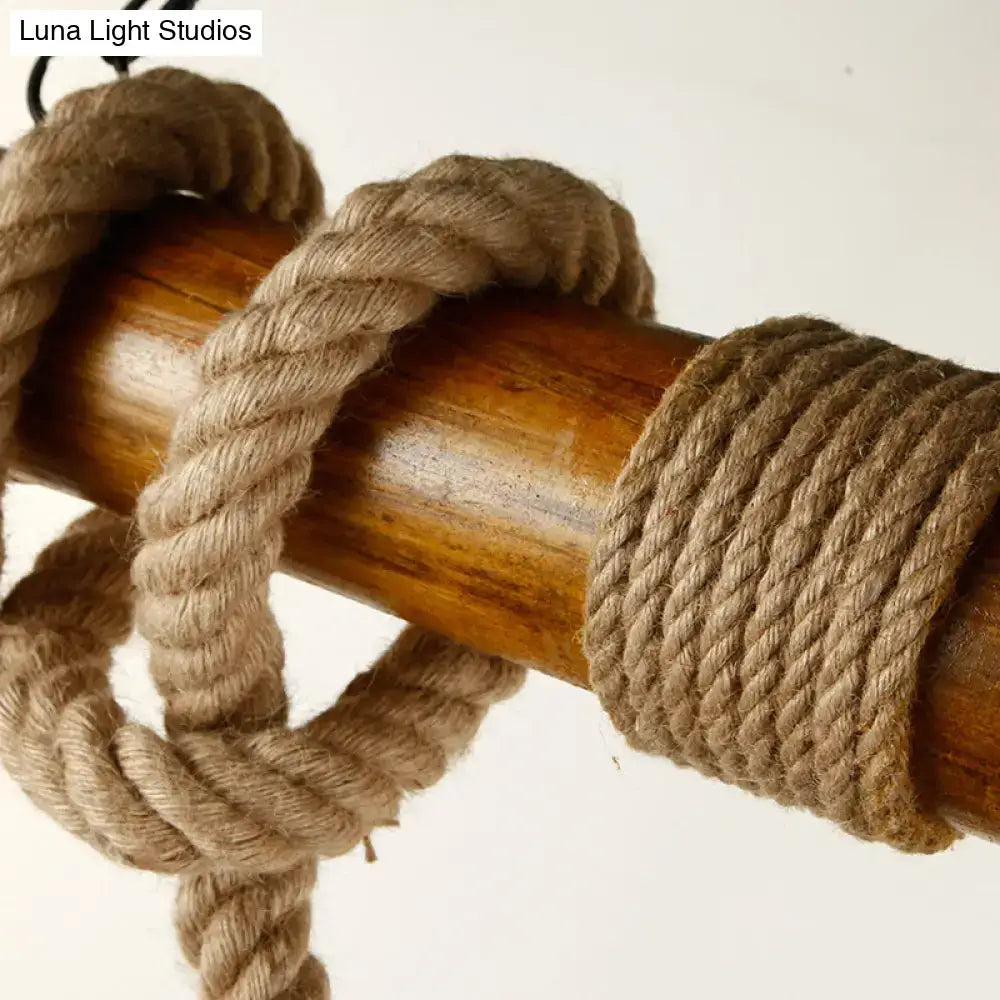 Natural fiber rope wrapped around a polished wooden pole on a rustic wooden beam and beige rope 3 light island pendant