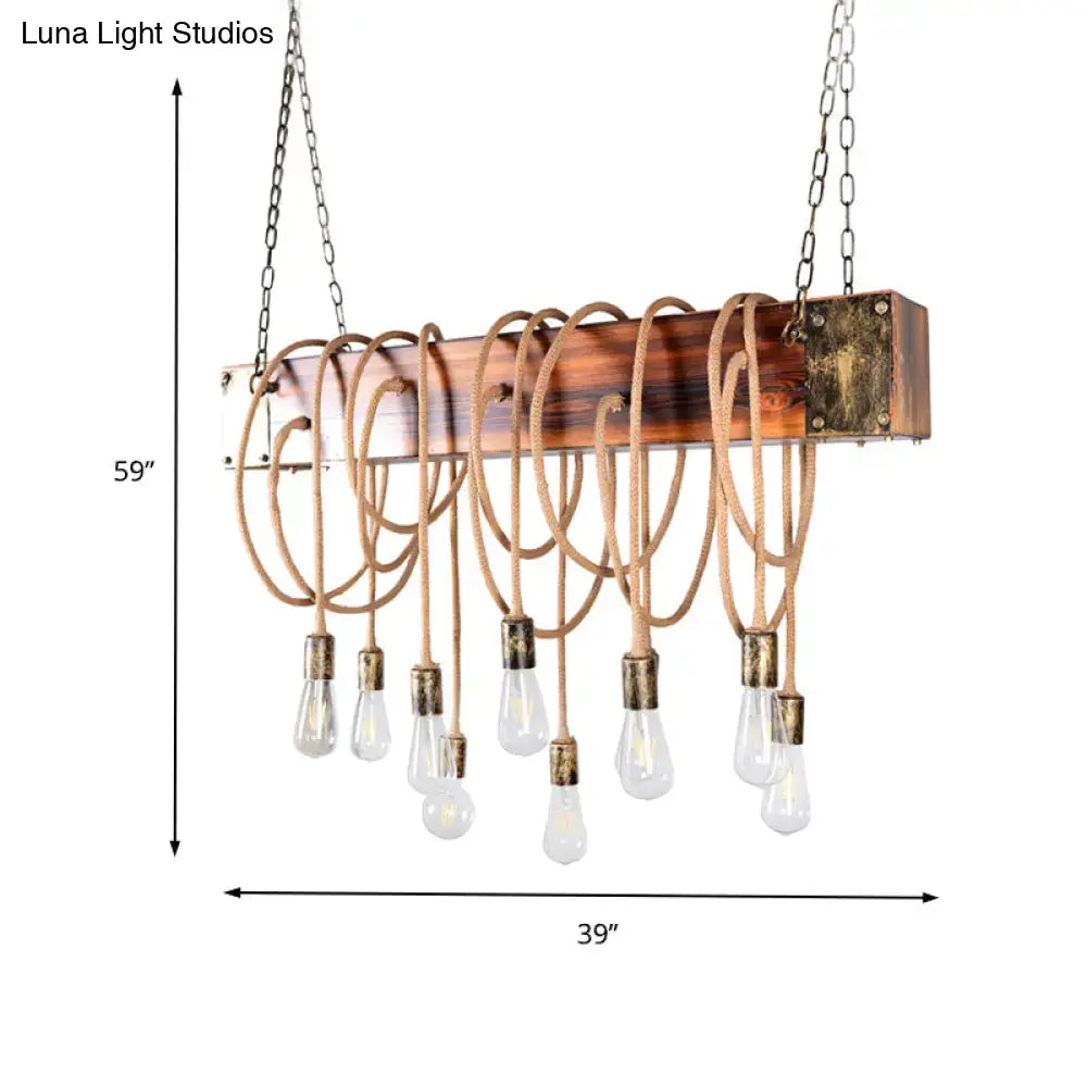 Rustic wooden beam chandelier with brass accents and exposed bulbs suspended by beige ropes in black antique brass finish