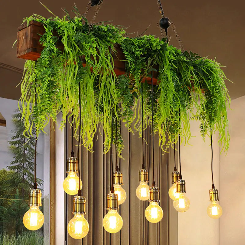 A rustic wooden planter with lush green fern deco hanging above vintage brass e26 e27 bulbs fixture width cluster