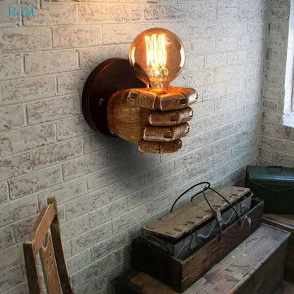 Rustic wooden hand model wall lamp with glowing filament bulb designed as wall lamps for vintage living room decor