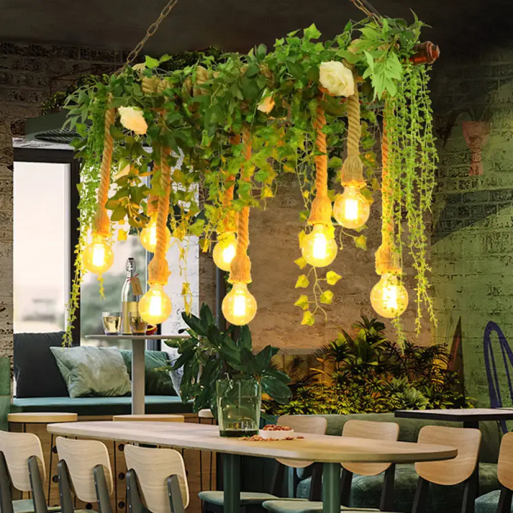 Rustic wooden island light fixture with exposed edison bulbs suspended by rope and decorative vines for dining room