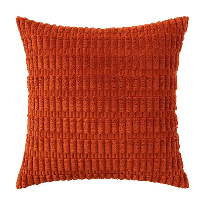 A rust-orange corduroy velvet throw pillow with vertical ribbed texture from a sage green corduroy pillowcase set