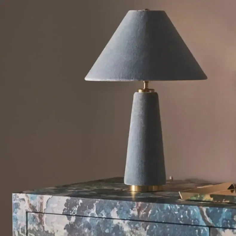 Gray velvet table lamp with conical base and gold fittings featured in decorbites cotton velvet floor lamp collection