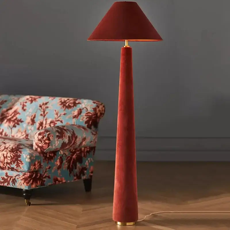 A tall slender floor lamp with deep red cotton velvet shade and base accented by gold metal fittings for living room decorbites cotton velvet