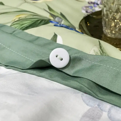 White round button with two holes sewn onto sage green fabric of decorbites 1400tc egyptian cotton bedding set