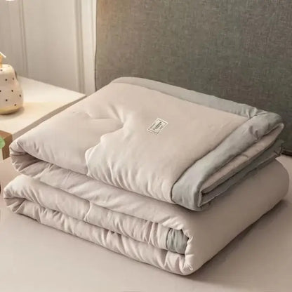 A soft beige decorbites cooling cotton quilt with subtle gray border and label for bedroom use