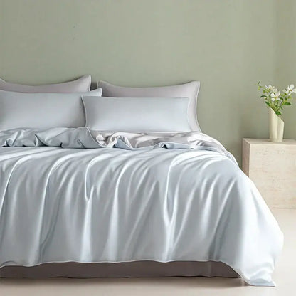 Light blue satin bedding set with solid color duvet cover and matching pillowcases featuring decorbites cool touch