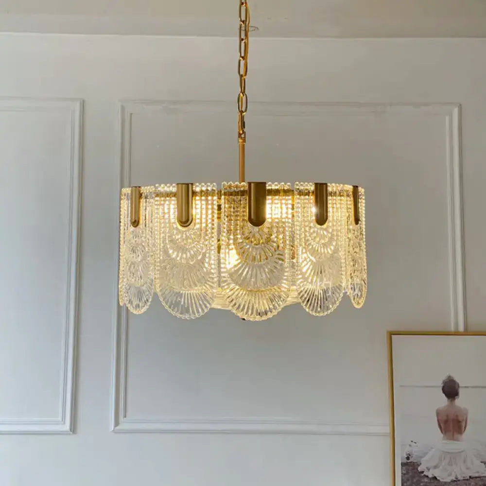 Gold-toned scalloped clear textured glass drop lamp with cascading fan-shaped crystal tiers for dining room use