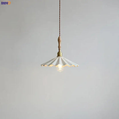 Scalloped white ceramic led pendant light with brass fixture and wooden handle hanging from braided cord decorbites ceramic led pendant