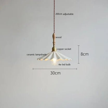 Scalloped white ceramic led pendant light with fluted design hanging from wooden handle and copper socket by decorbites ceramic led