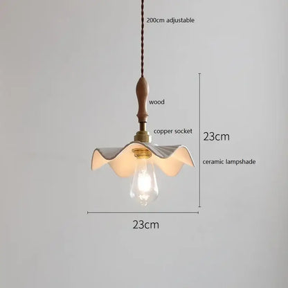 Scalloped white ceramic led pendant light with wavy petal design hanging from wooden handle copper socket