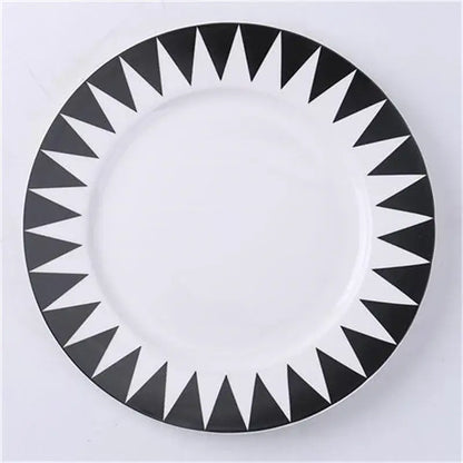 A white ceramic dessert plate with bold black triangular geometric pattern perfect for Scandinavian dining