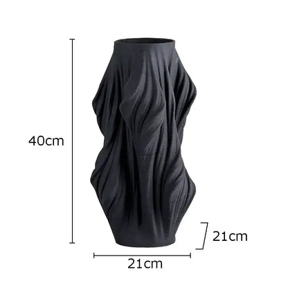 Black ceramic vase with sculpted flowing ribbed texture from decorbites ceramic vase set for bedroom decor