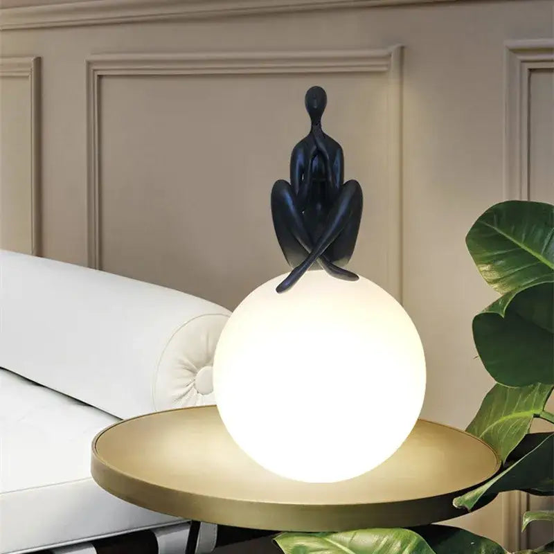 Sculptural black and red glass ball table lamp with abstract figurine for bedroom decorbites glass ball lighting