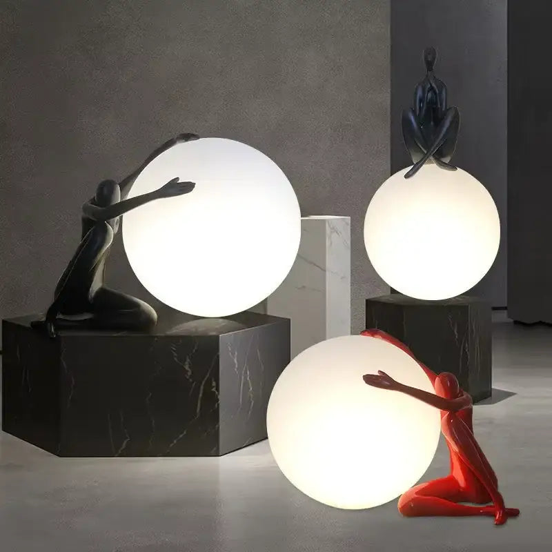 Sculptural black and red glass ball table lamp with dynamic figurines on dark marble bases for bedroom decorbites decor