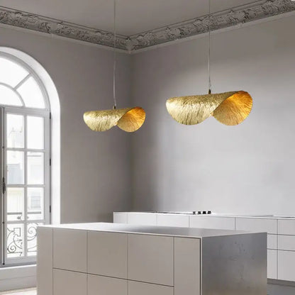 Two elegant golden brass lotus leaf pendant lights with textured finish hang in dining room decorbites brass lotus chandelier