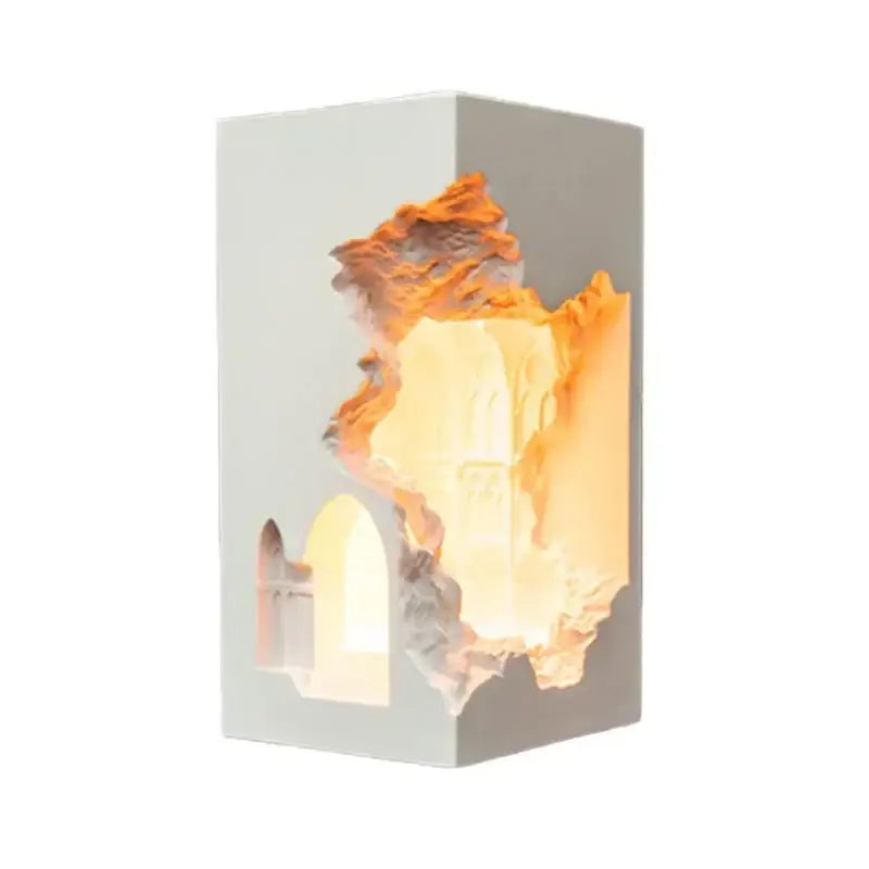 A modern rectangular wall sconce with a white exterior and an embedded night light featuring textured stone interior