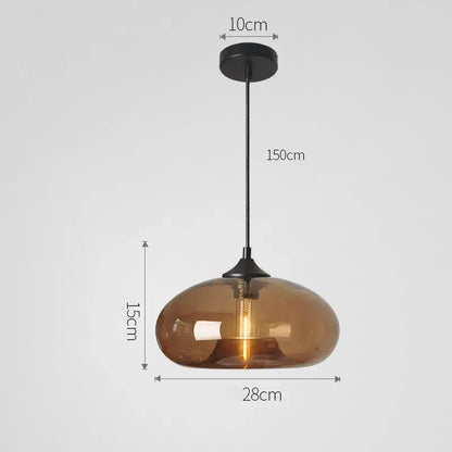 A sleek amber glass pendant light with black metal fixture part of decorbites colorful glass pendant set for dining room