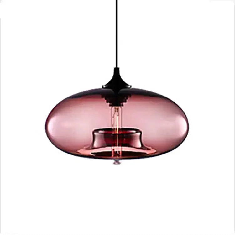 A sleek oval-shaped pendant light with translucent rose-gold glass shade and black metal fixture decorbites colorful glass