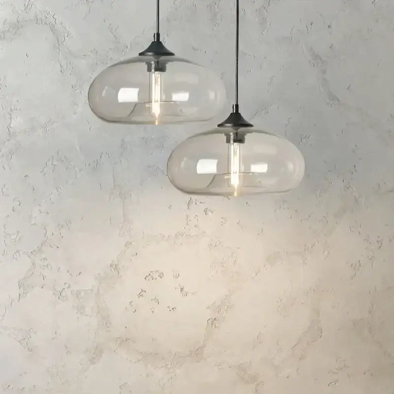Two modern glass pendant lights with black metal fixtures and exposed filament bulbs from decorbites colorful glass pendant set