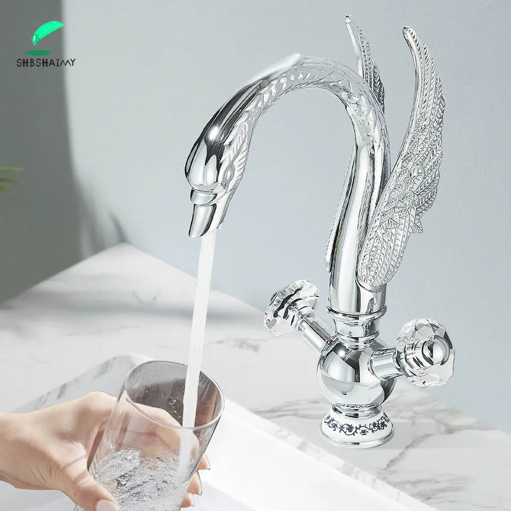 Silver swan-shaped deck mounted bathroom faucet with ornate wing detailing cold water crystal knobs gold brass