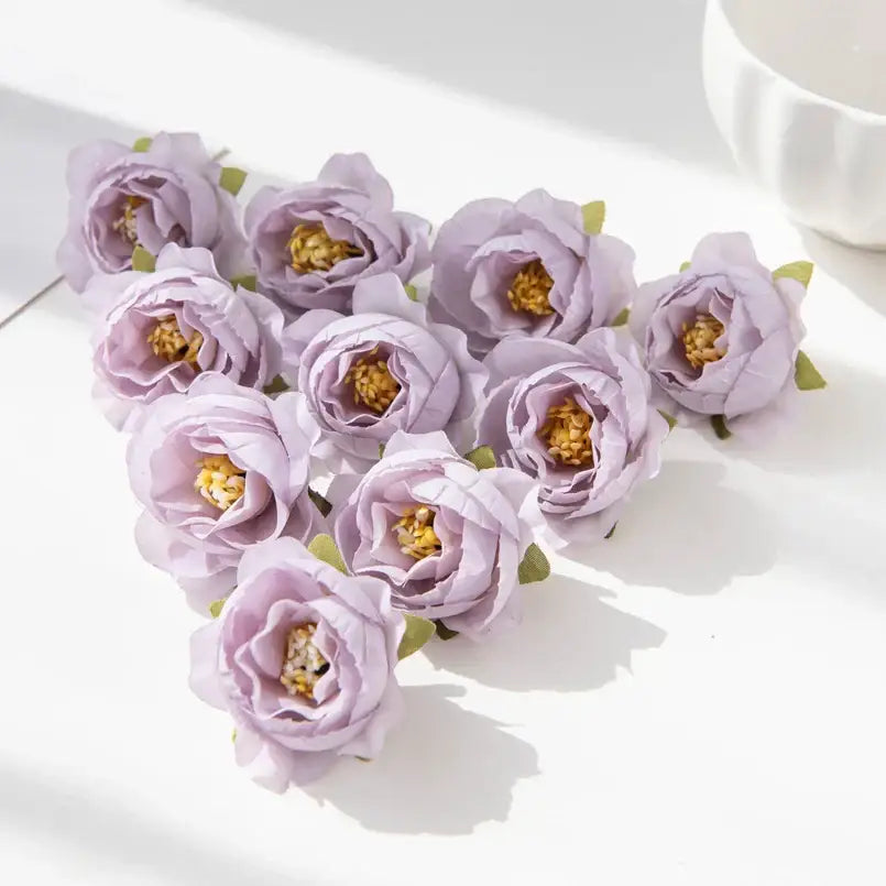 A cluster of delicate lavender silk peony flowers with golden centers and green stems for wedding and home decor