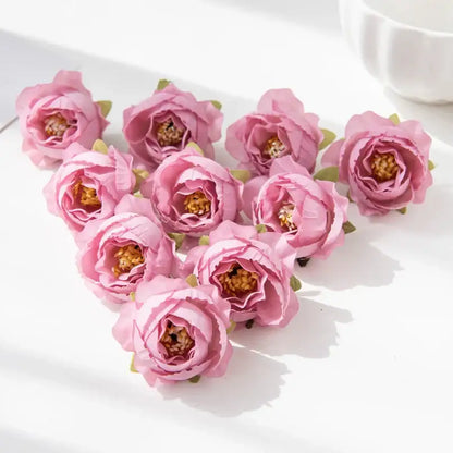 A cluster of delicate pink silk peony flowers with soft layered petals and golden centers for wedding and home decor