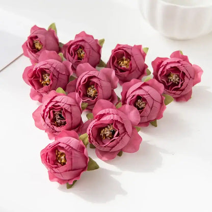 A cluster of artificial pink silk peony flowers with layered petals green stems and detailed golden centers for decor