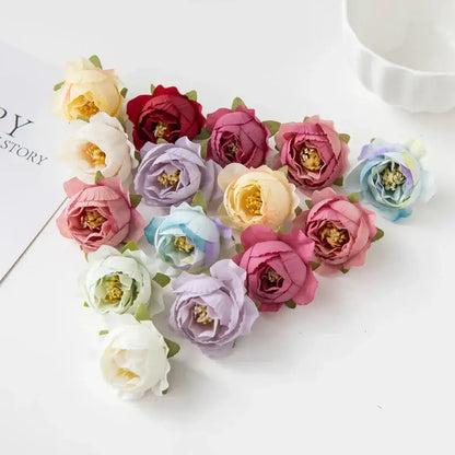A silk peony flower collection featuring delicate artificial pastel pink lavender cream and red peonies with yellow centers for decor