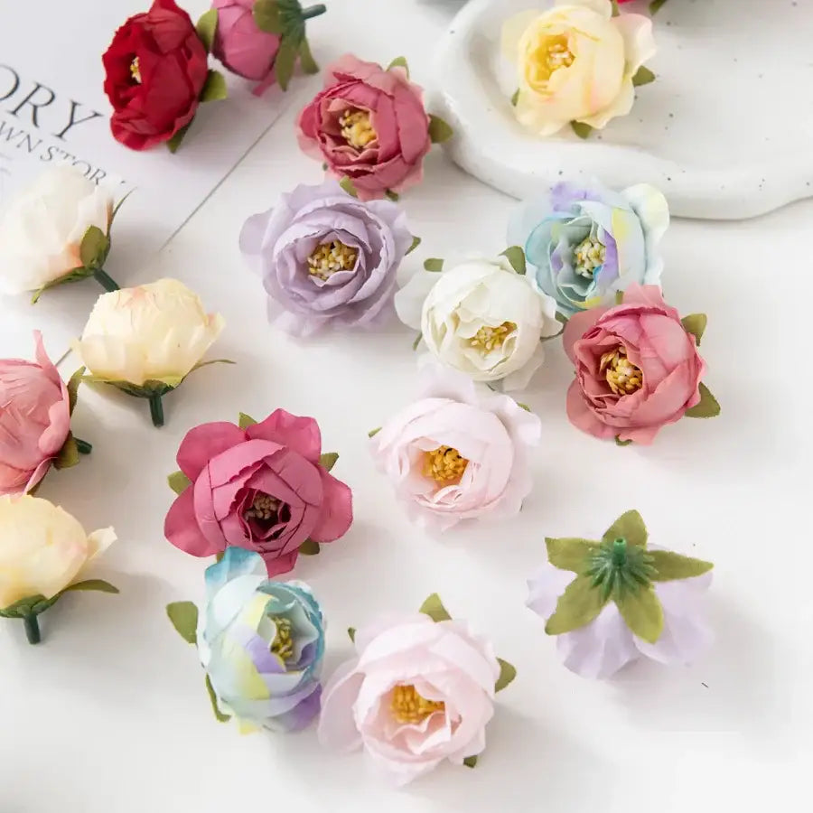 A silk peony flower collection featuring delicate pastel pink, lavender, cream, and pale blue artificial peonies for wedding decor