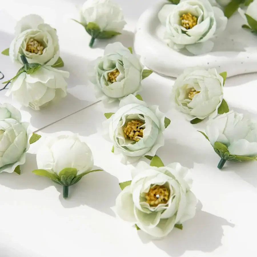 Delicate white silk peony flowers with soft layered petals and vibrant yellow centers for wedding and home decor