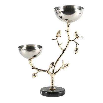 Silver and gold metal snack bowl stand with tree branch design, bird figurines, and polished silver bowls for dining room fruit