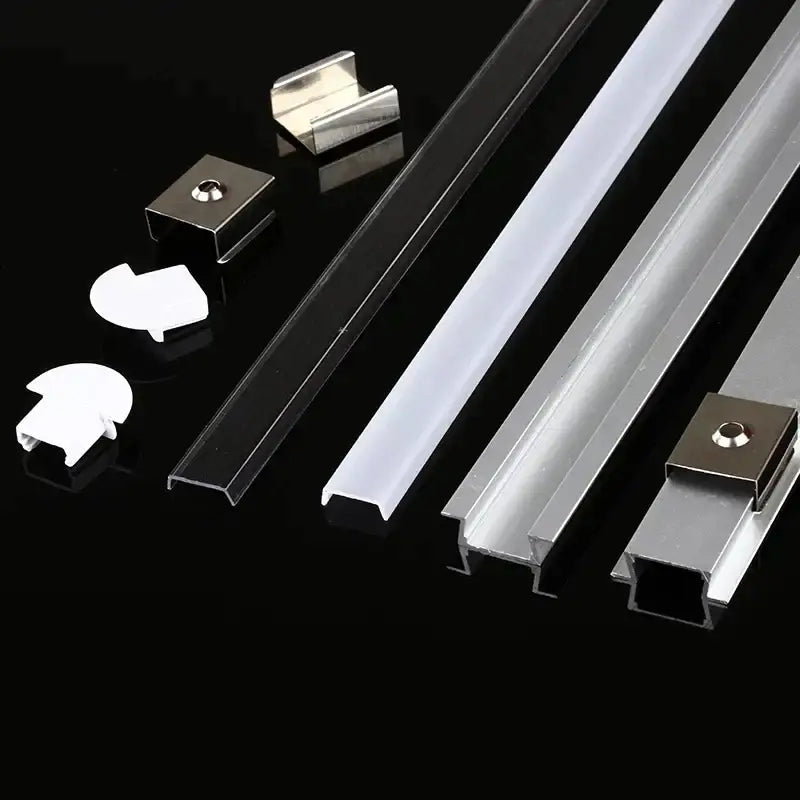 Set of sleek silver and black aluminum profile recessed led strip channels with matching mounting brackets for kitchen use