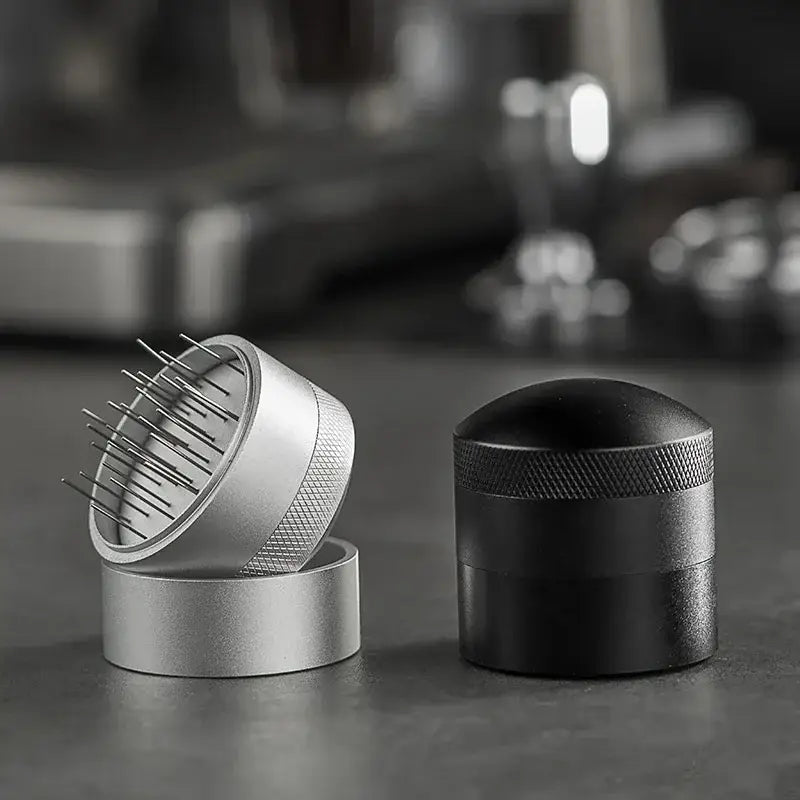 Silver and black decorbites coffee needle distributor with textured grips and fine metal tines for espresso stirring