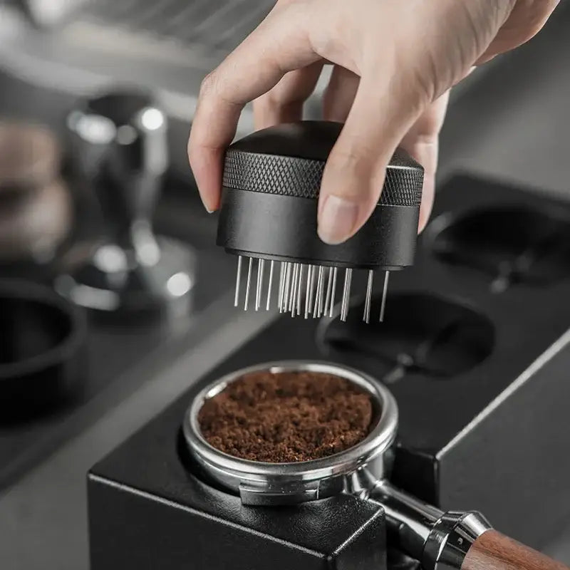 Silver and black decorbites coffee needle distributor with textured grip and fine prongs for espresso stirring