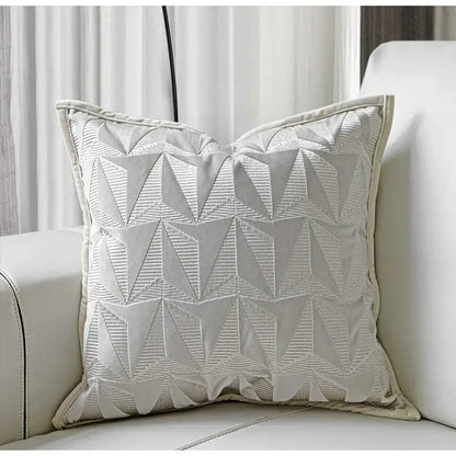 Off-white pillow cover with silver geometric embroidery and textured stitched triangles for luxe living room decorbites conical geometric design