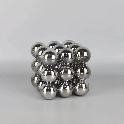 A cube-shaped stack blocks sculpture made of polished silver crystal glass ball spheres for living room decor
