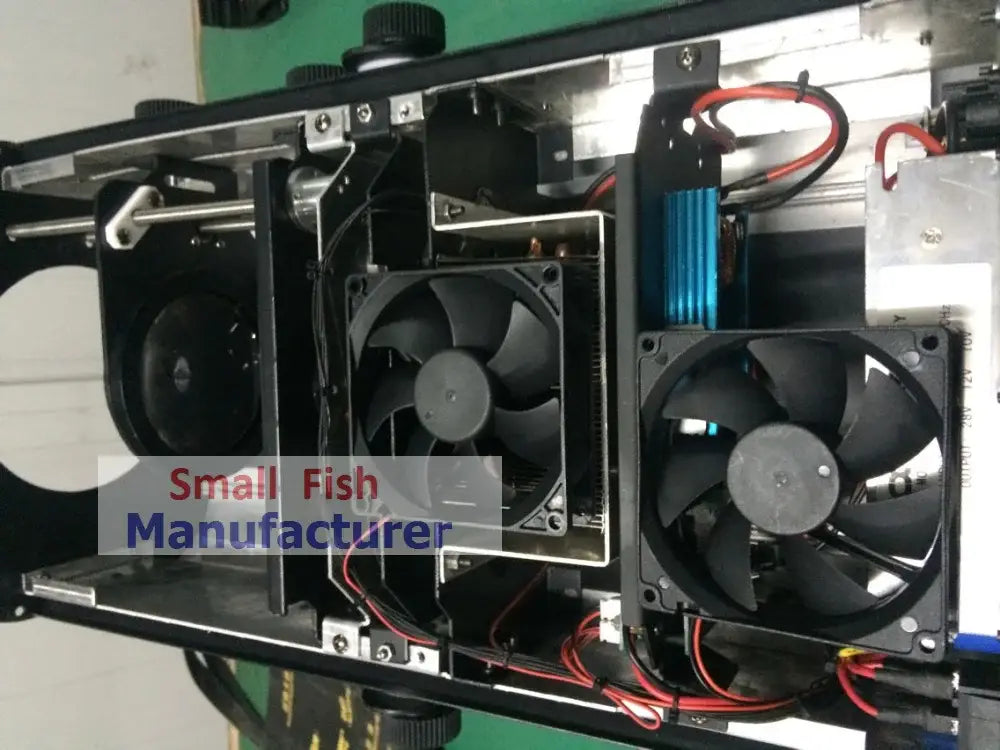Black cooling fans with metallic frames mounted inside the back of a silver metal 300w led follow spot light for wedding decor