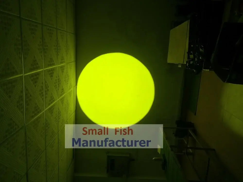 A glowing yellow spherical light fixture mounted on a tiled wall in a silver metal 300w led follow spot light design