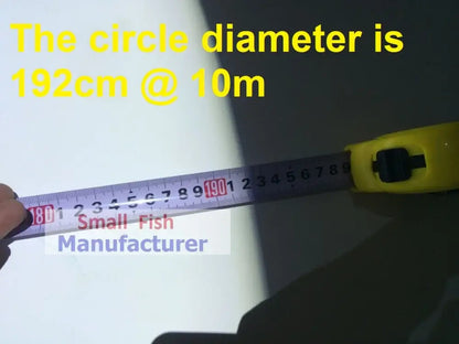 Yellow tape measure with black markings and metallic blade measuring components of a silver metal 300w led follow spot light