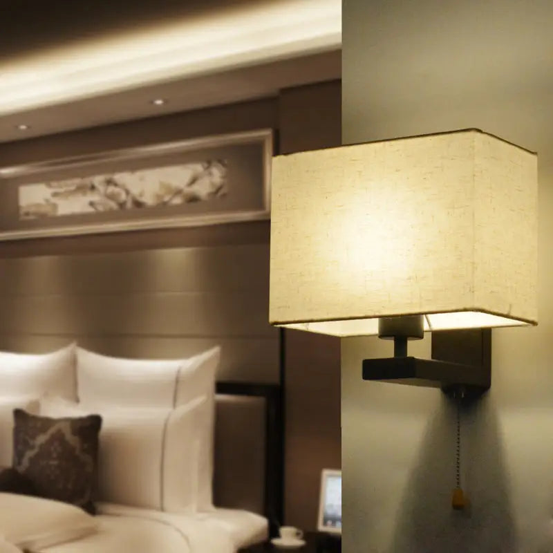 Simple beige fabric rectangle wall lamp with warm-toned square shade on dark metal e26 e27 light fixture for bedroom