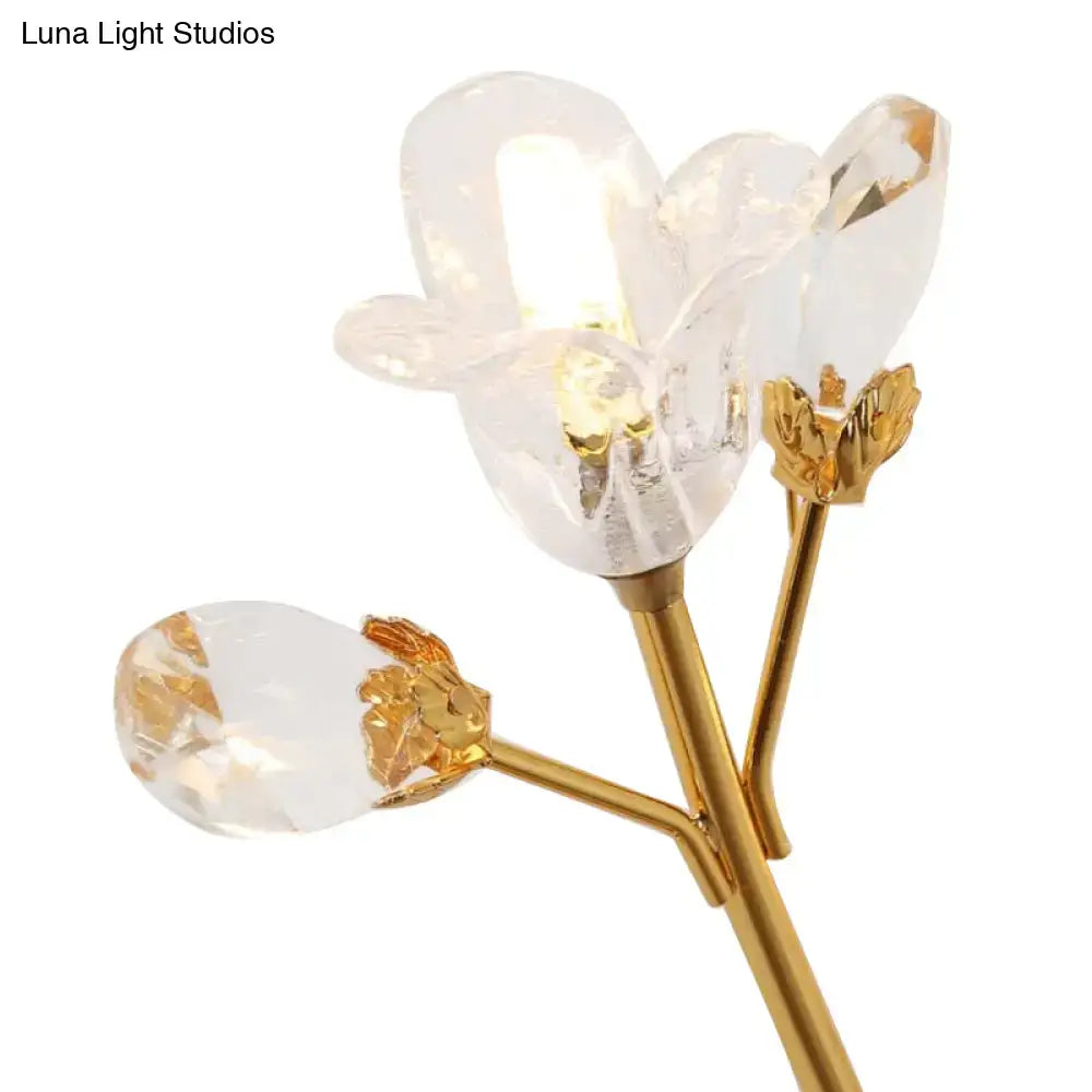 Simple gold crystal flowers wall sconce with delicate gold-toned stem and clear faceted crystal blossoms for bedroom lighting