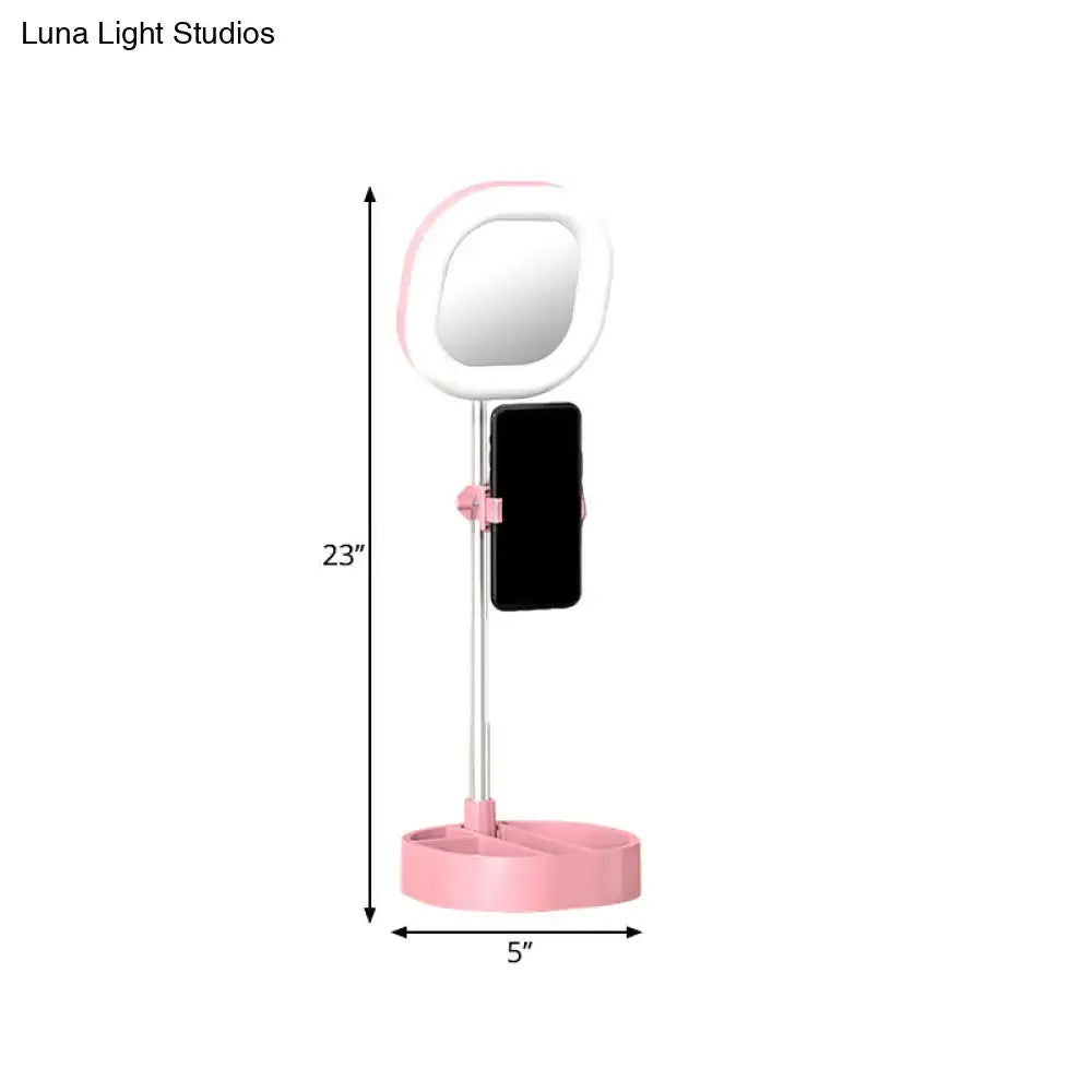 Pink and white led mirror light vanity with phone holder designed for bedroom use with simple light blue led illumination